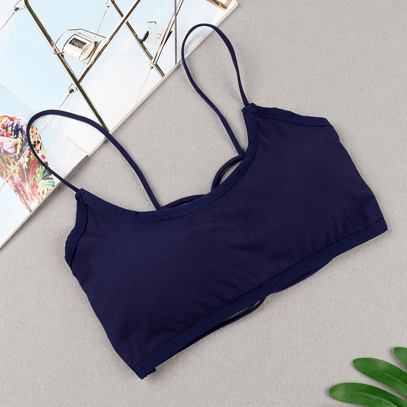 Stylish wireless navy blue women's sports bra with open back, perfect for yoga and active wear. Comfortable and breathable fit.